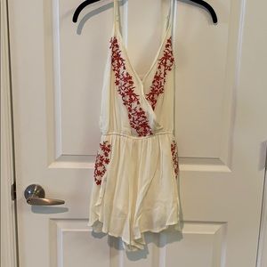White romper with red floral detailing